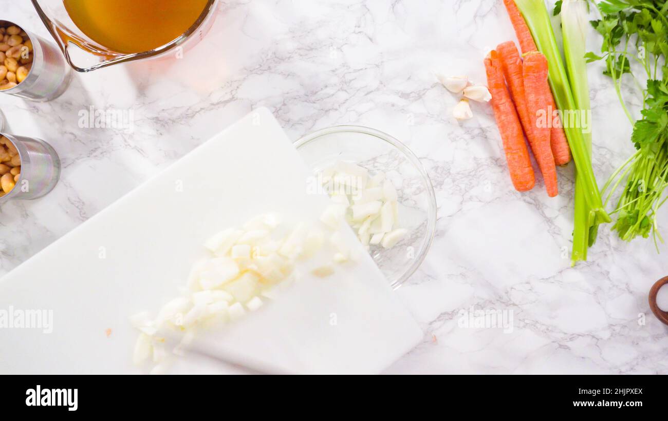 Curring vegetables on a white cutting board to cook vegetarian white
