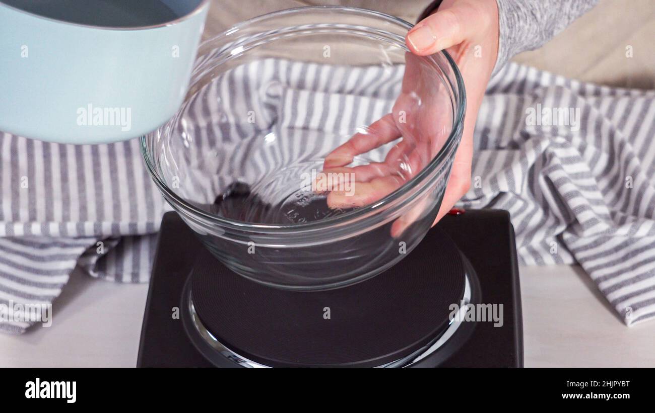 Step by step. Preparing sugar syrup in a small saucepan over an