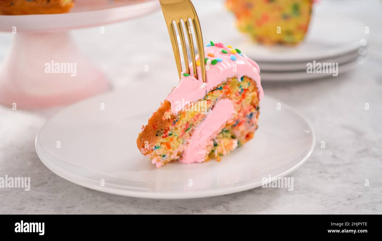 Step by step. Slicing funfettti bundt cake with pink buttercream frosting on top and buttercream