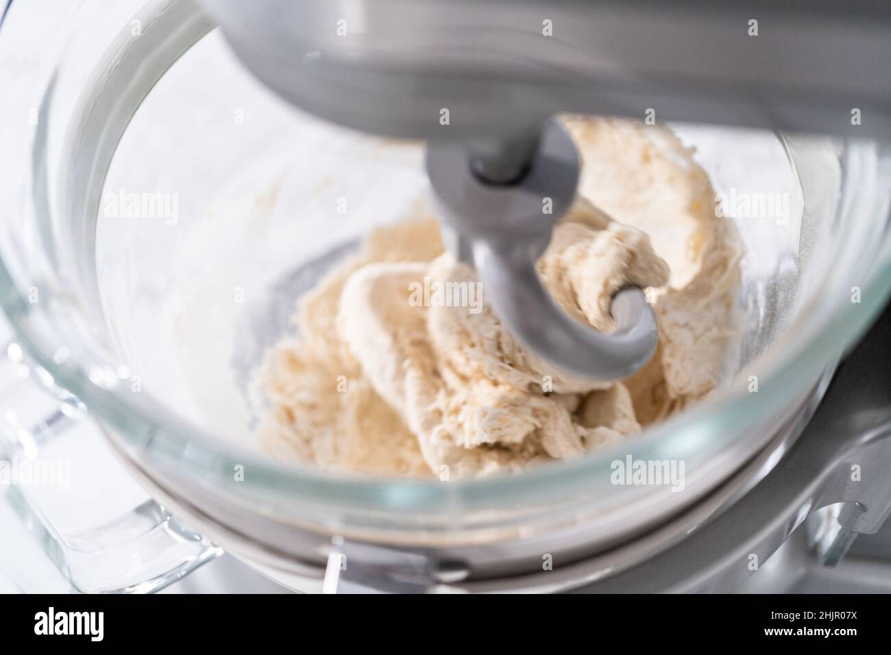 https://c8.alamy.com/comp/2HJR07X/mixing-ingredients-in-a-large-glass-mixing-bowl-to-pizza-dough-2HJR07X.jpg