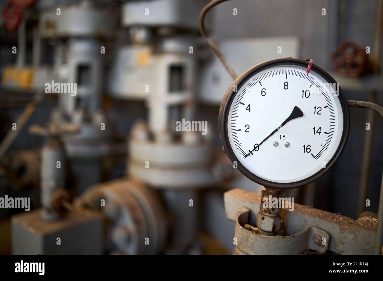 Pressure gauge or manometer shows zero closeup with crane or valve