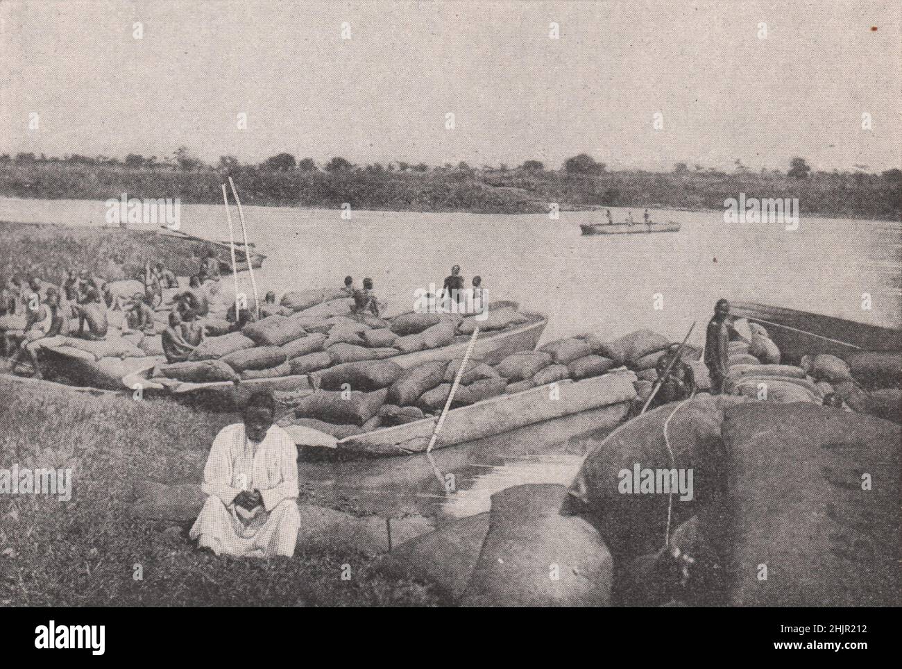 Natives of Uganda bringing seed cotton across lake Kioga. East Africa (1923) Stock Photo