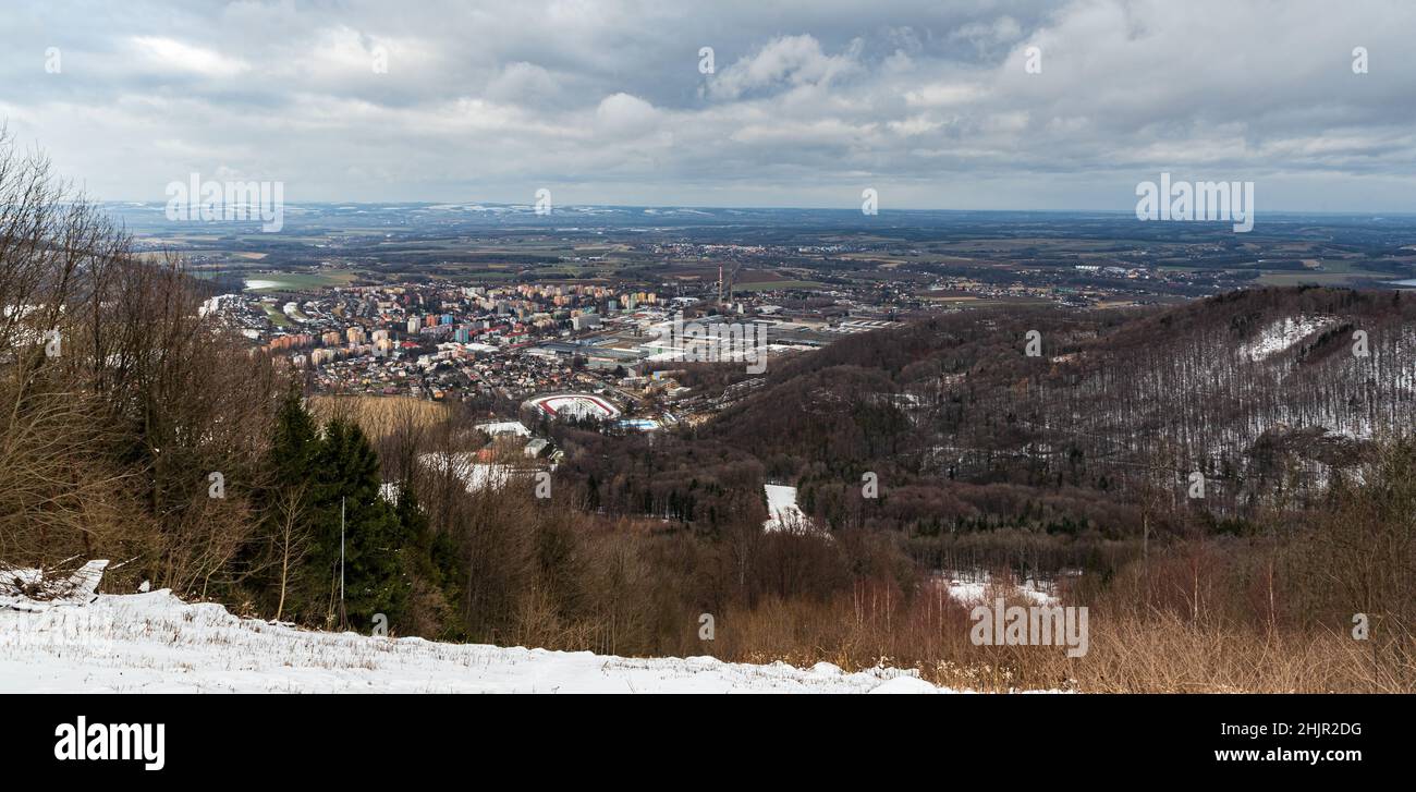 View from Cerveny kamen hill above Koprivnice town in Czech republic during cloudy winter day Stock Photo