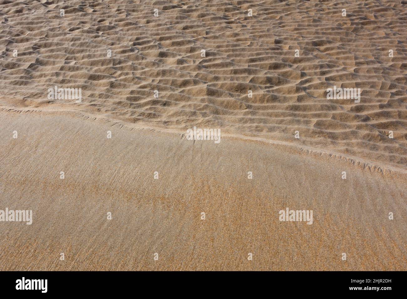 Wet sand meets dry sand on beach abstract Stock Photo
