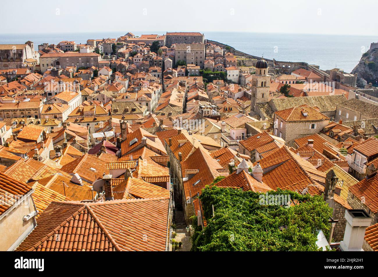View of Traditional Colorful Rooftops and Franciscan Church and Monastery Bell Tower with Adriatic Sea in the Background Stock Photo