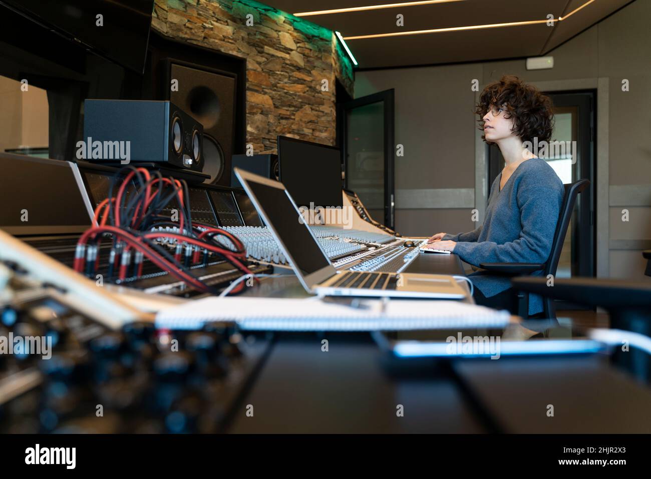 Young curly hair caucasian woman working in a music studio Stock Photo