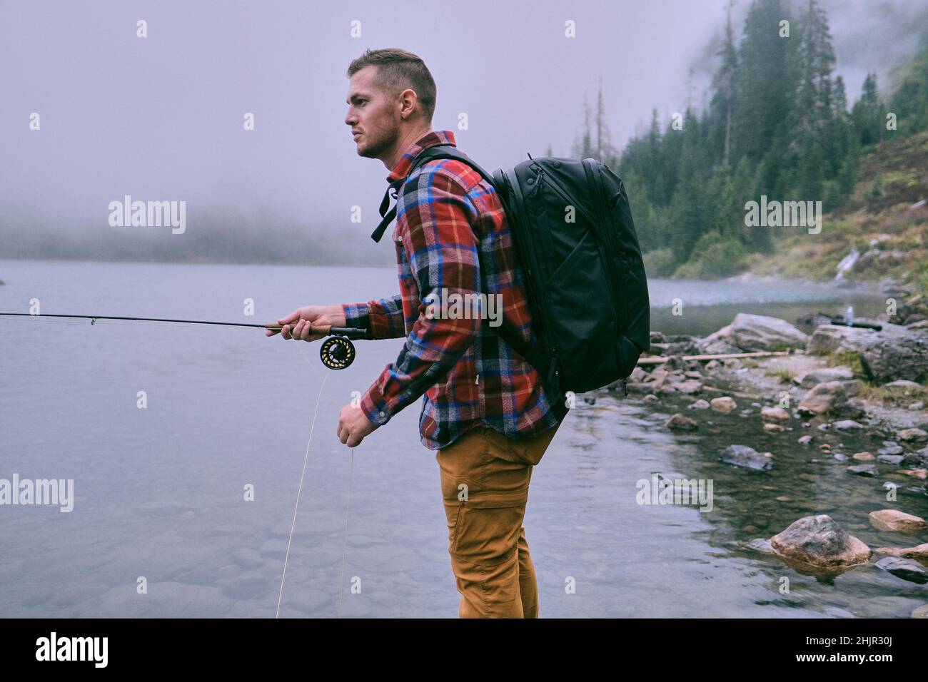 A man dressed in flannel fly fishing at Lake 22 in Washington Stock Photo Alamy