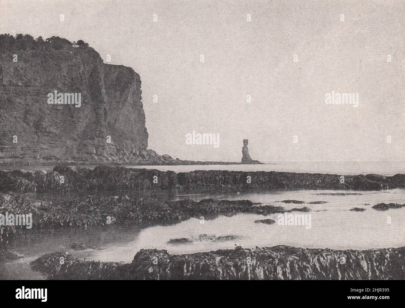 Dawlish, the red cliffs of glorious Devon and a stone sentinel. England (1923) Stock Photo
