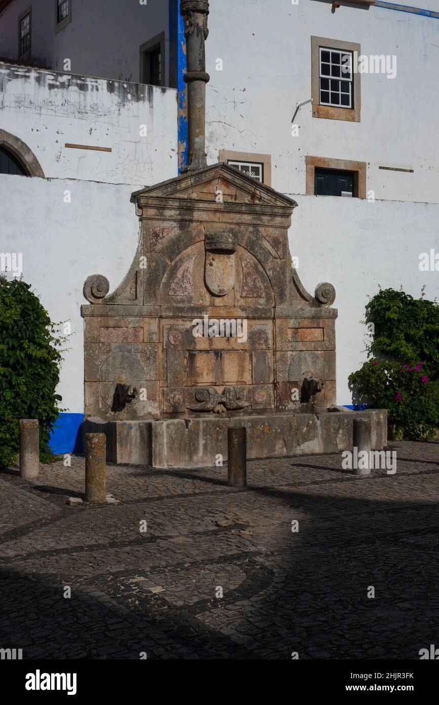 Mannerist or late Renaissance drinking fountain, commissioned 1575, in main square at Óbidos, Portugal Stock Photo