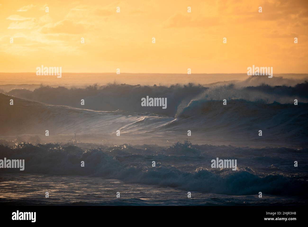 Misty Sunset over Waves on North Shore of Oahu Stock Photo