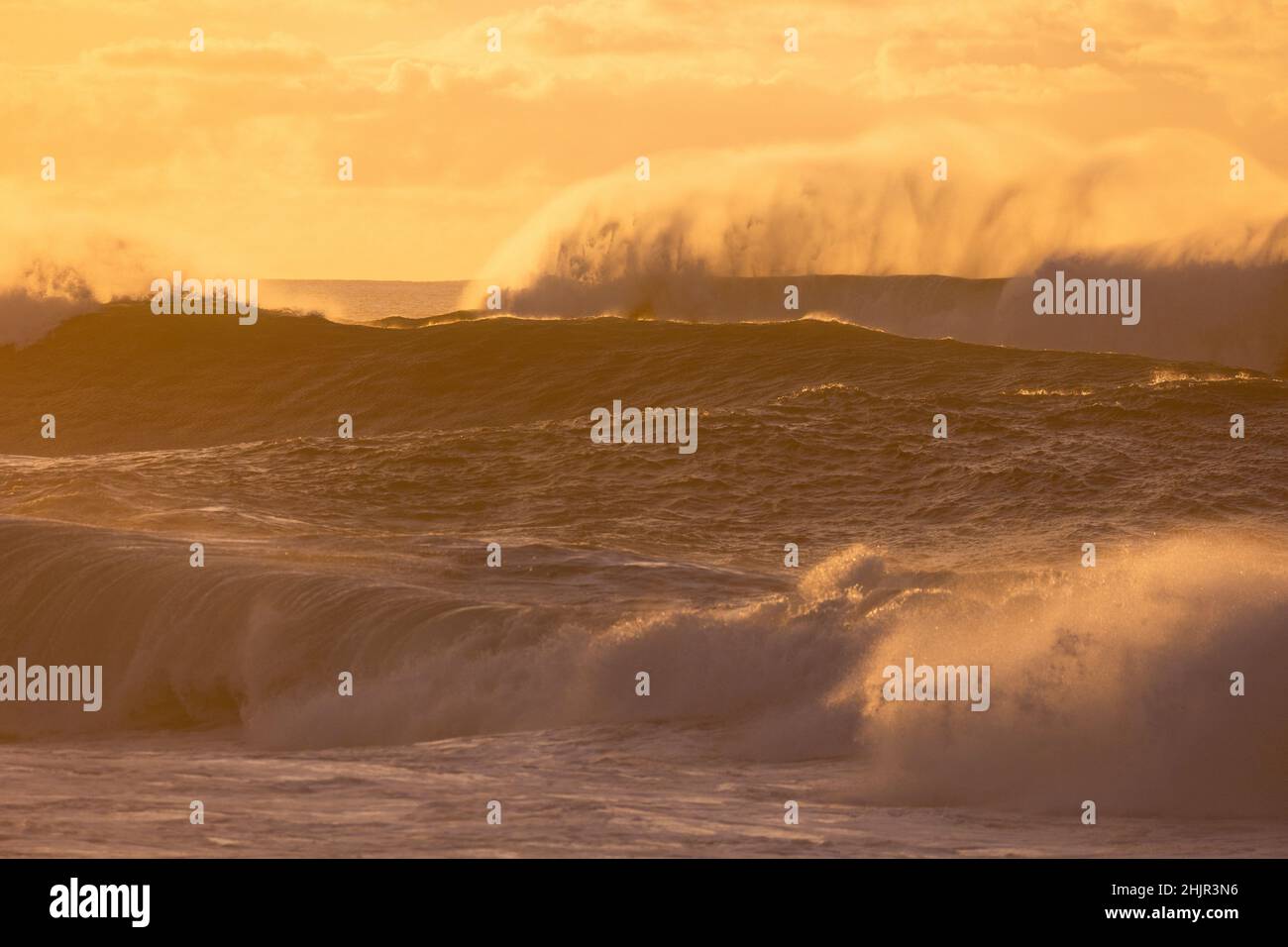 Misty Sunset over Waves on North Shore of Oahu Stock Photo