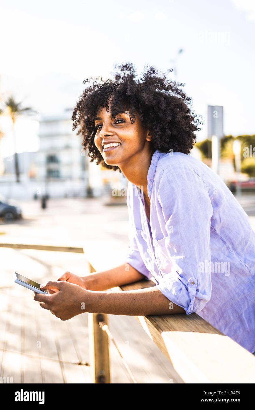 Beautiful young black woman happy while using her smartphone Stock ...