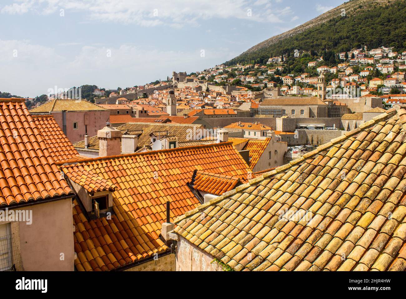 View of Traditional Colorful Rooftops of Dubrovnik with Minceta Tower and City Walls in the Background Stock Photo