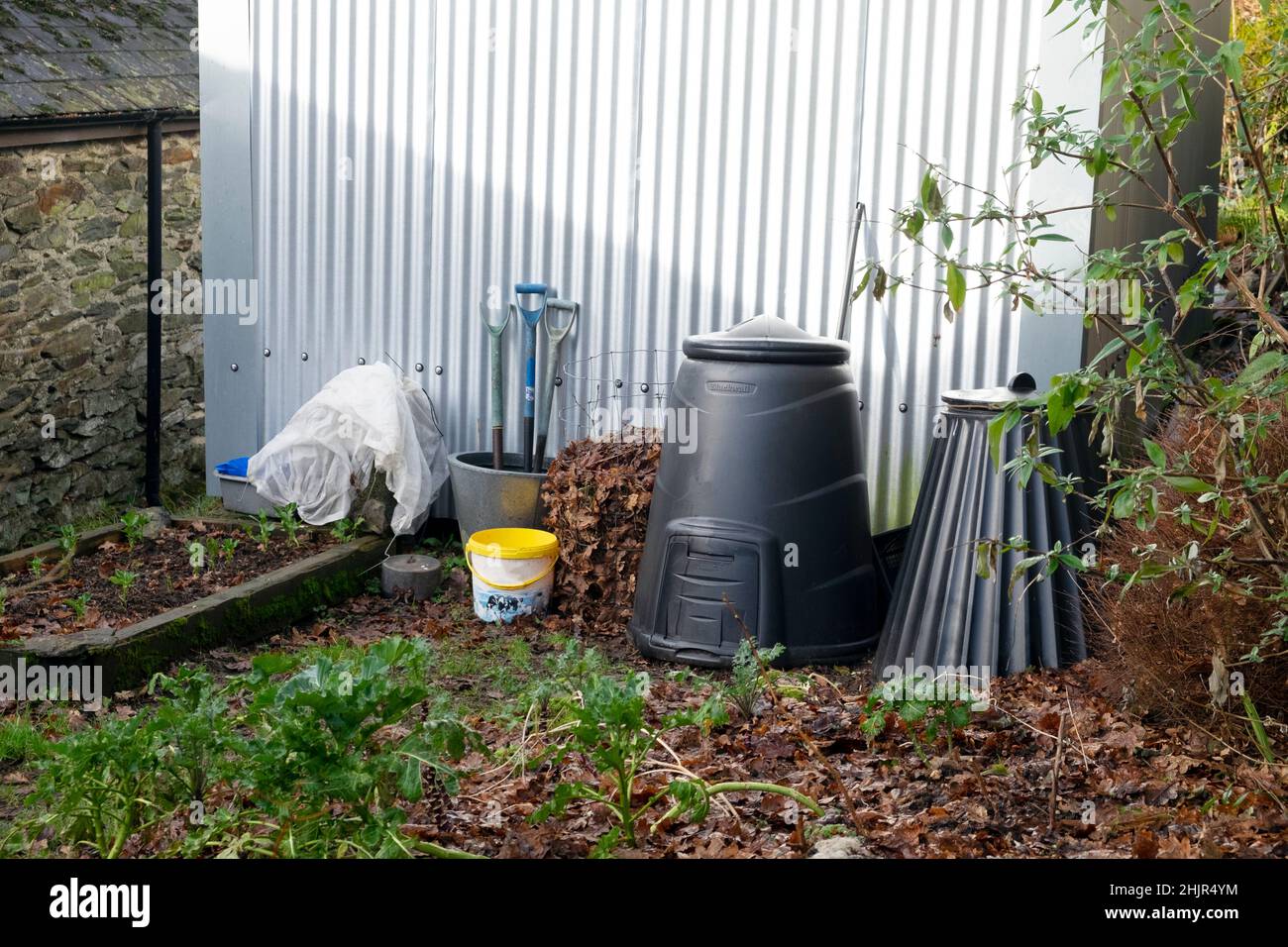 Black compost bins for recycling food wast in an autumn winter garden