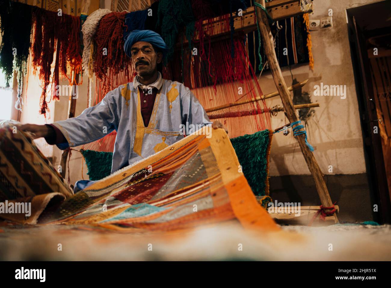 Front view of an Arab vendor of handmade carpets. Stock Photo