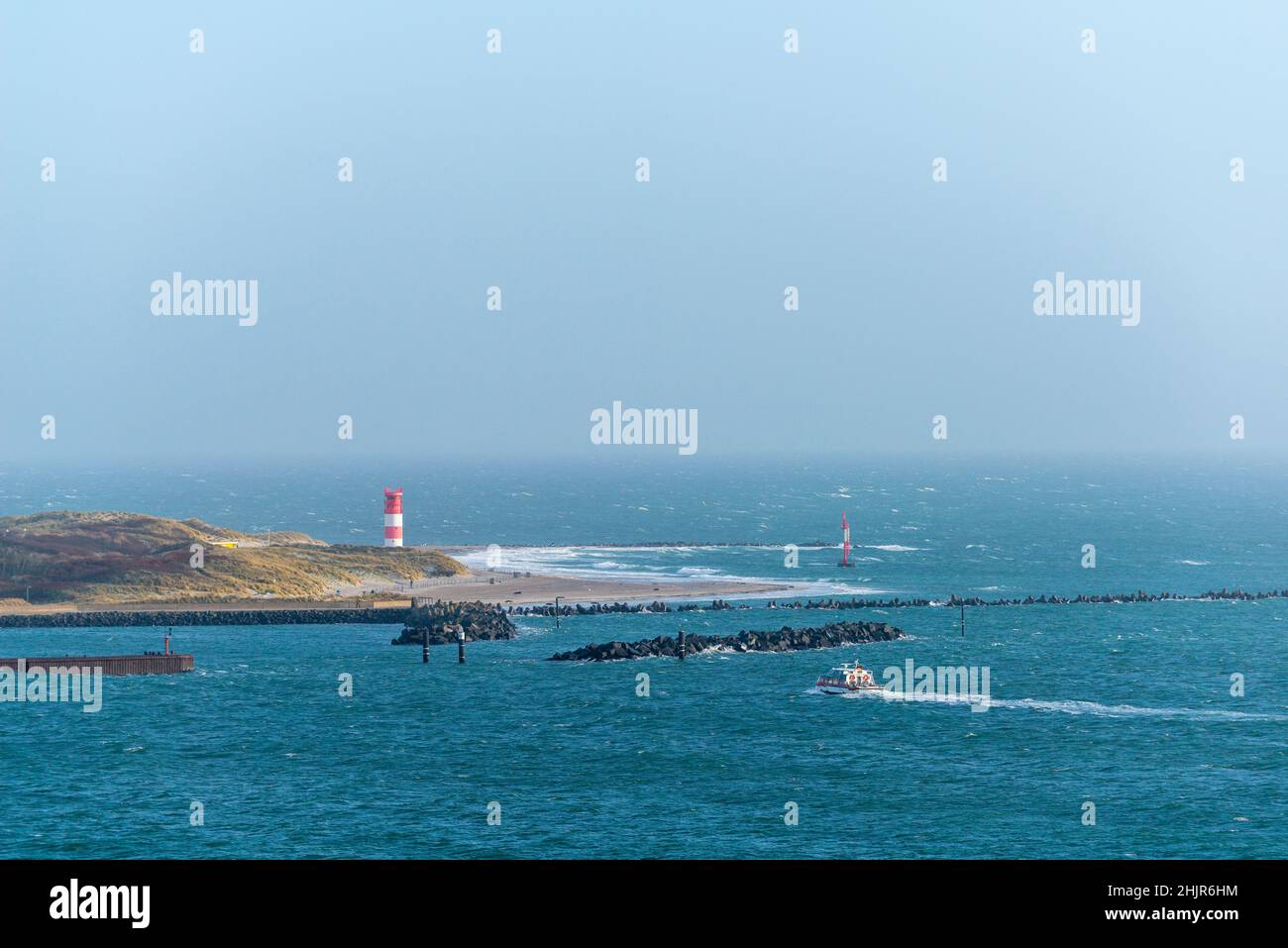 Lighthouse on the beach of The Dune in stormy weather, high seas island of Heligoland, North Sea, Northern Germany, Central Europe Stock Photo