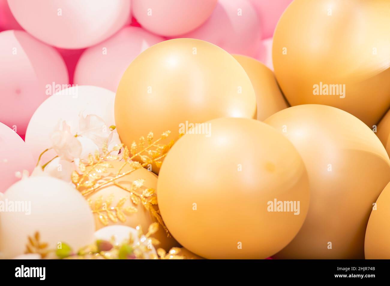 Festive decoration area with big gold and pink balloons and