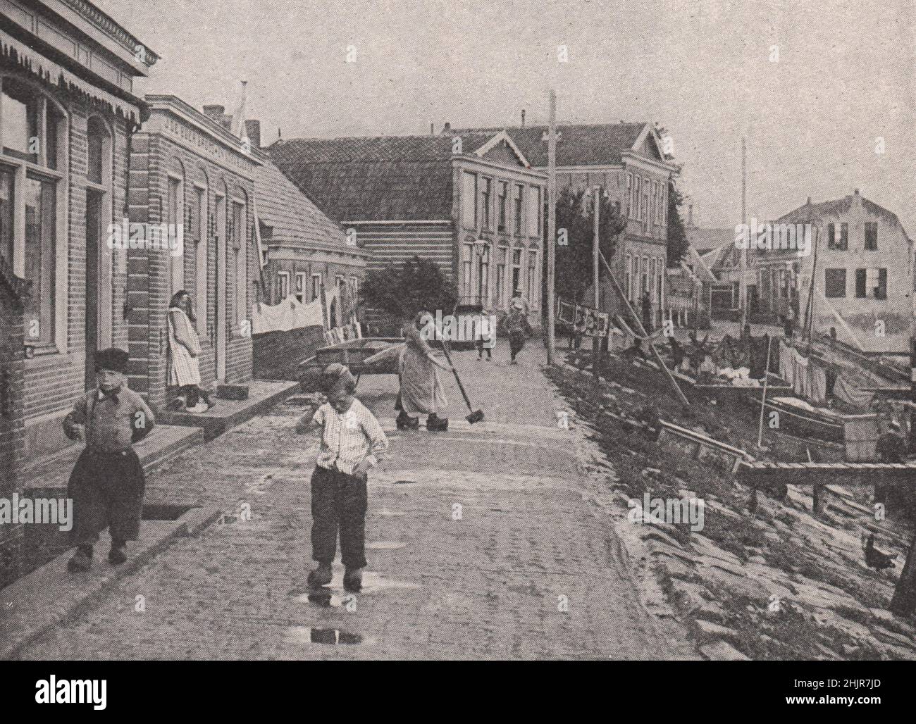 Everyday life on the Dyke at Volendam on the Zuider Zee. Netherlands. Holland (1923) Stock Photo