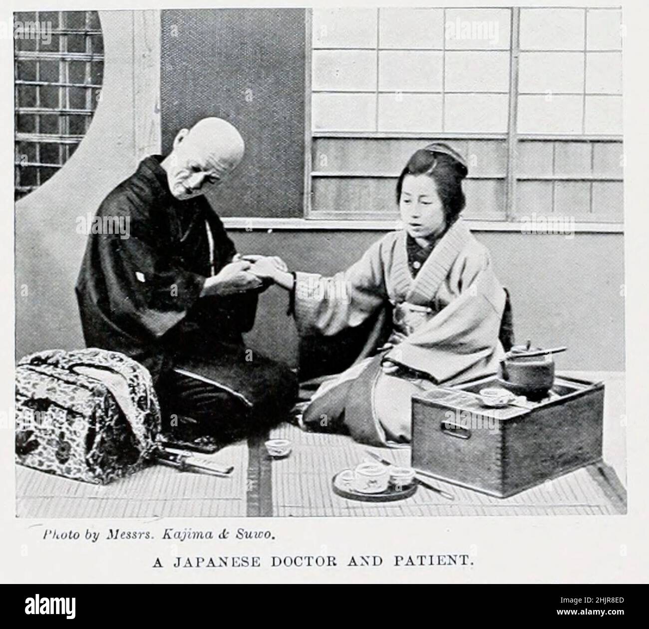 A Japanese doctor and patient from the book '  The living races of mankind ' Vol 1 by Henry Neville Hutchinson,, editors John Walter Gregory, and Richard Lydekker, Publisher: London,  Hutchinson & co 1901 Stock Photo