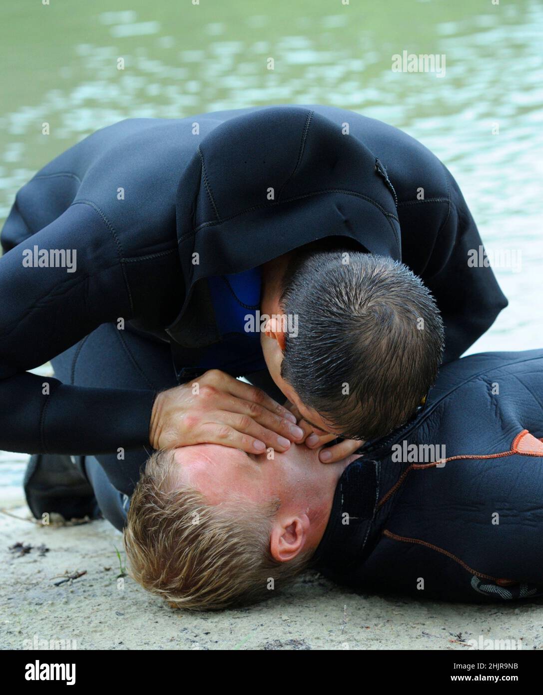 Artificial respiration. Lifeguard giving drowning mouth-to-mouth resuscitation. Stock Photo