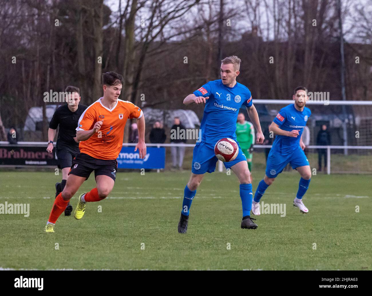 Warrington Rylands 1906 FC hosted Glossop North End for a mid-season non-league football match of the 2021-2022 season. Matty Hughes protects the ball Stock Photo