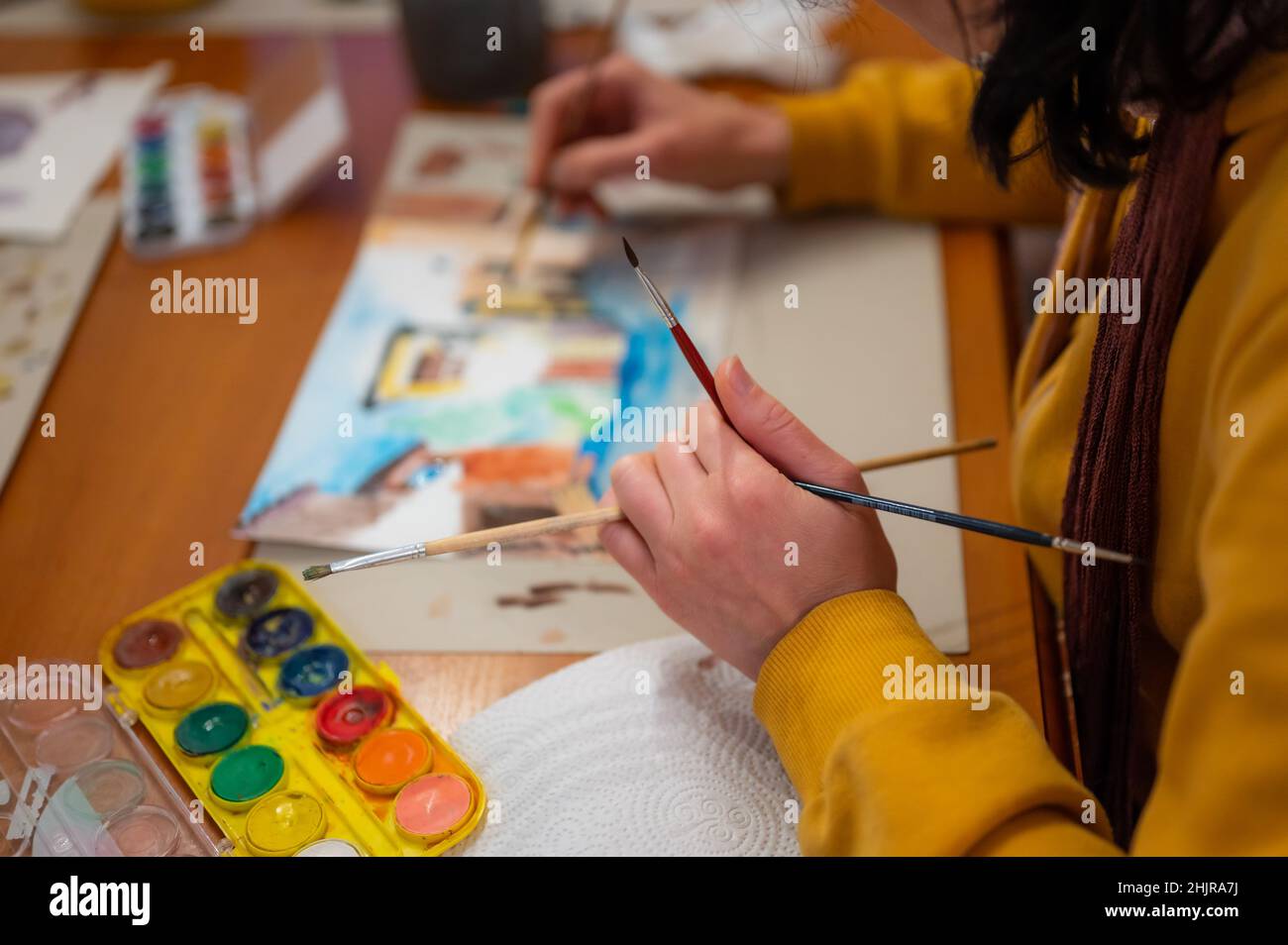 Process of creative art workshop. Artist painting colorful architecture ...