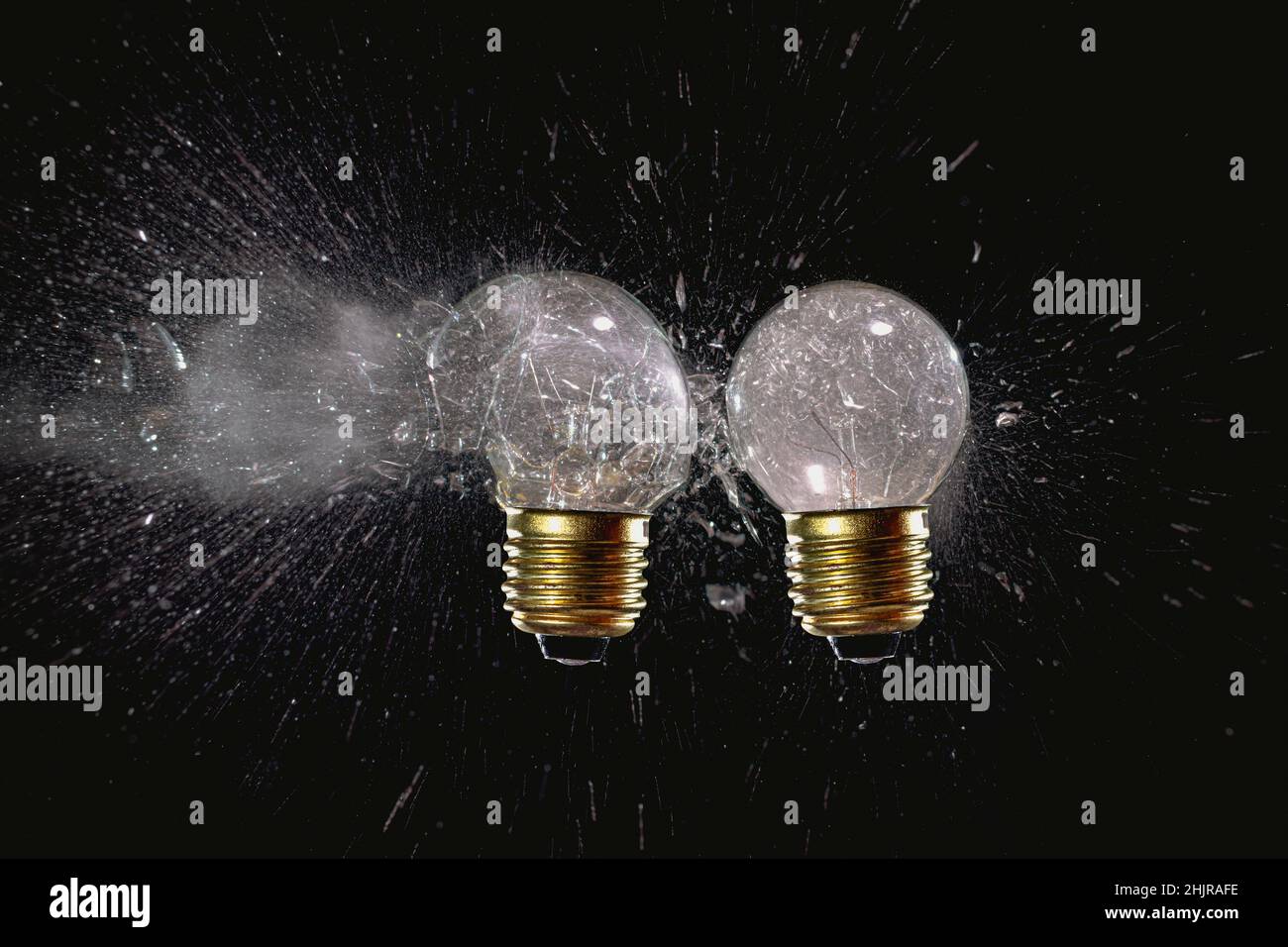 traditional light bulbs with exploded glass on black. Stock Photo