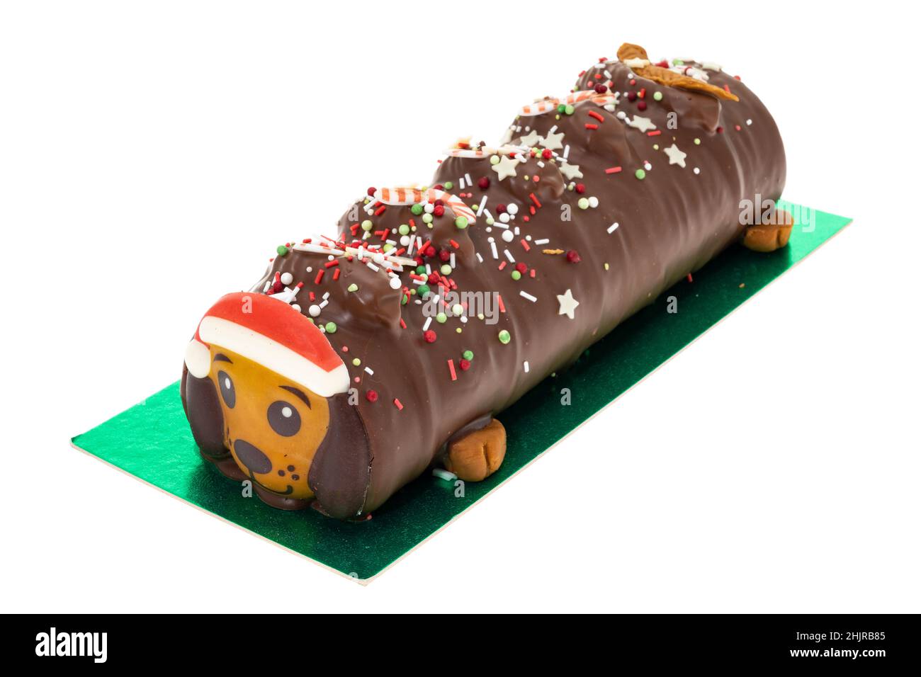 A Christmas themed dog shaped chocolate yule log - white background Stock Photo