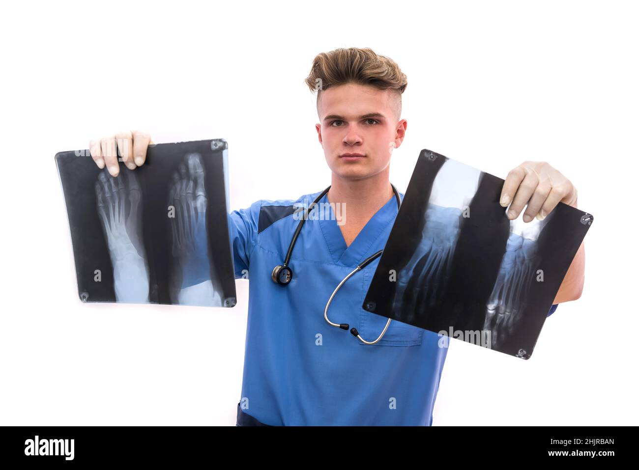 Handsome and young doctor holding foot x-ray of a patient . Medical help concept Stock Photo