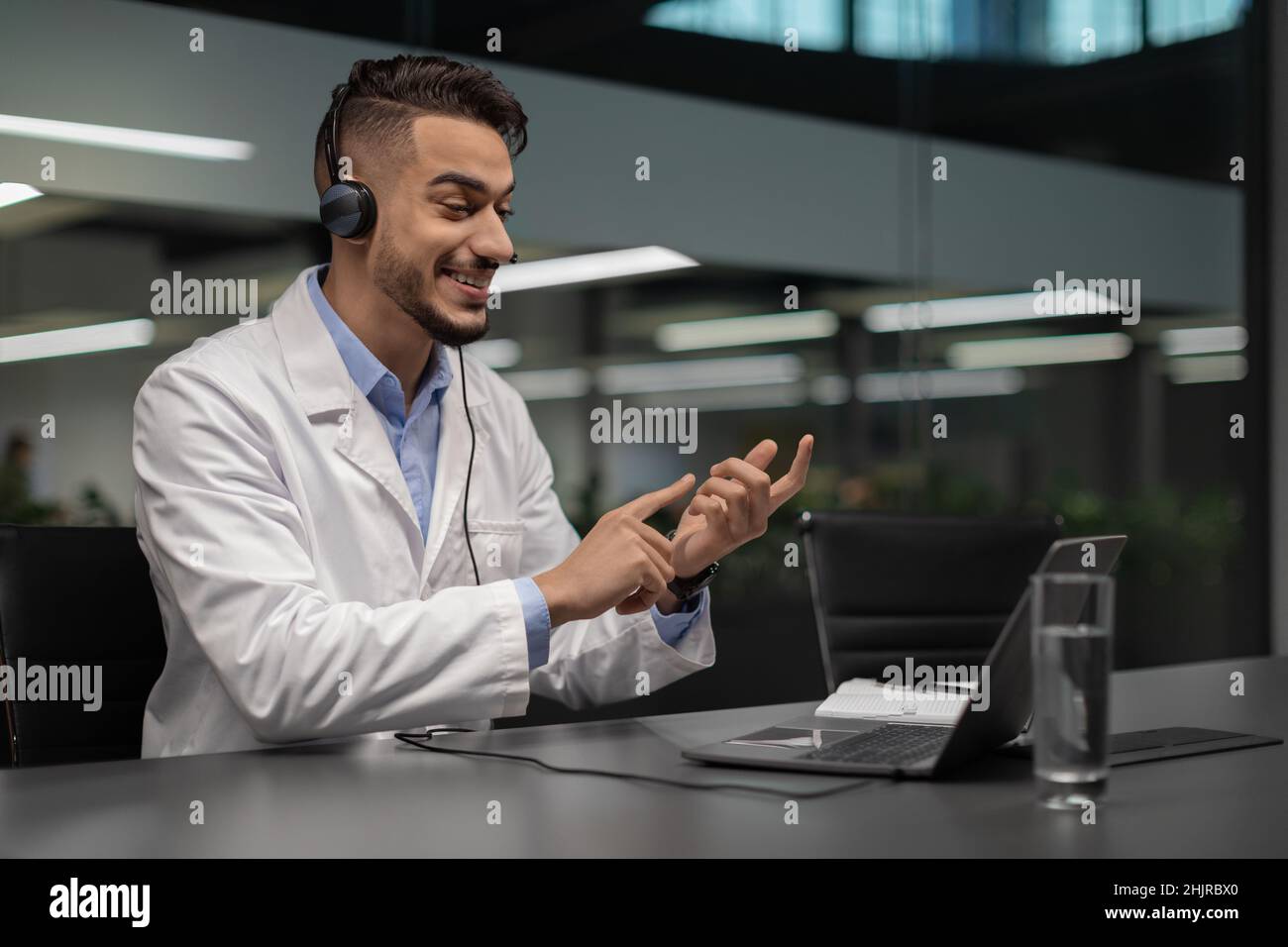 Handsome young middle eastern scientist using laptop at office Stock Photo