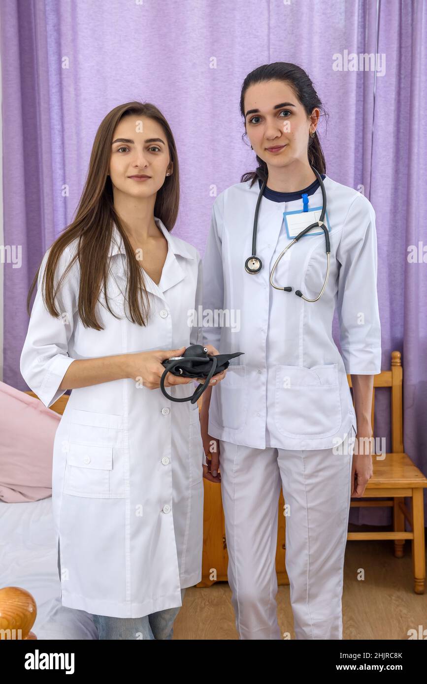 Smiling doctors young and confident posing in hospital for camera Stock Photo