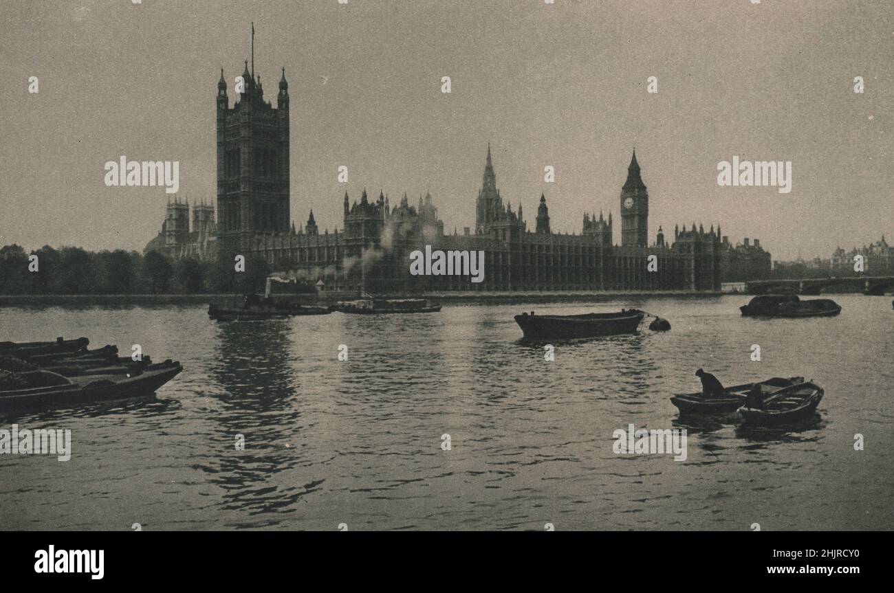 Victoria Tower, Big Ben & the Houses of Parliament, dominate the Thames from the north bank. On the left can be seen Westminster Abbey. London (1923) Stock Photo