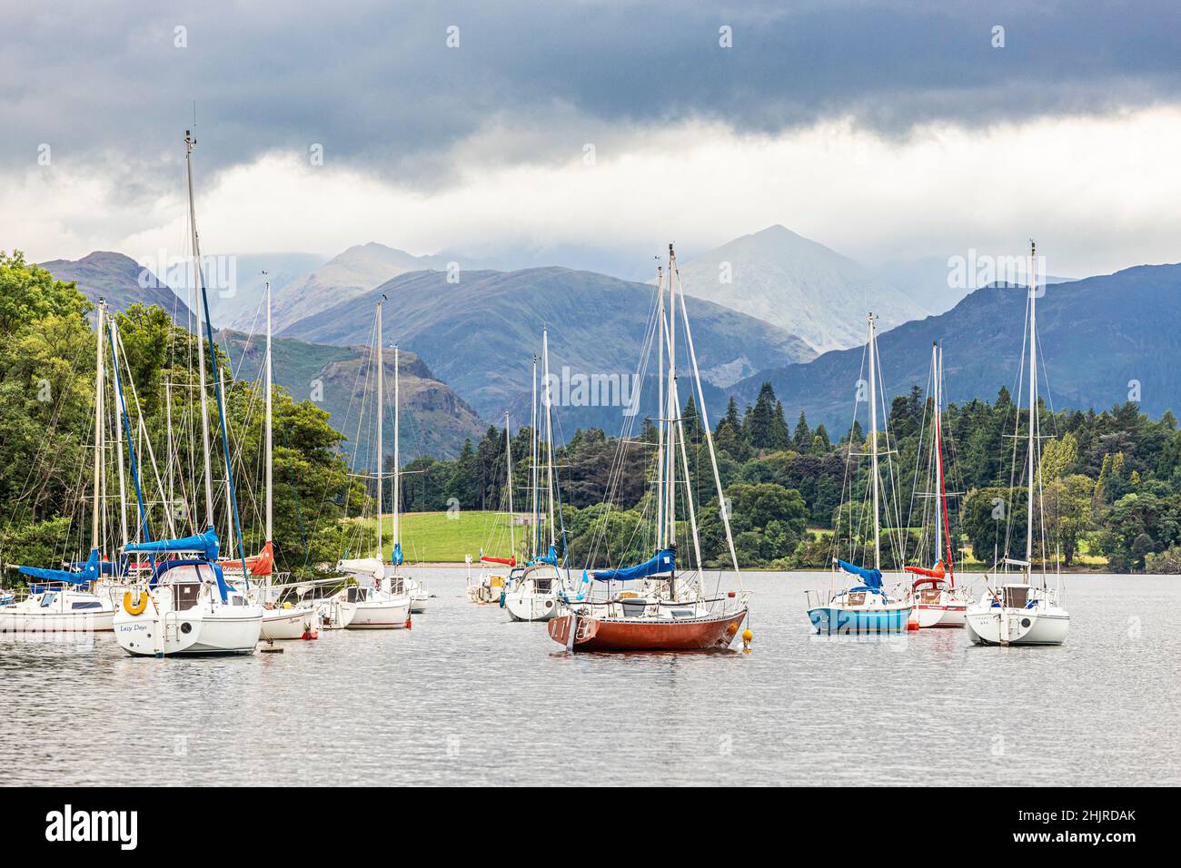 Yachts on Ullswater in the English Lake District looking towards Helvellyn under heavy cloud, Cumbria UK Stock Photo
