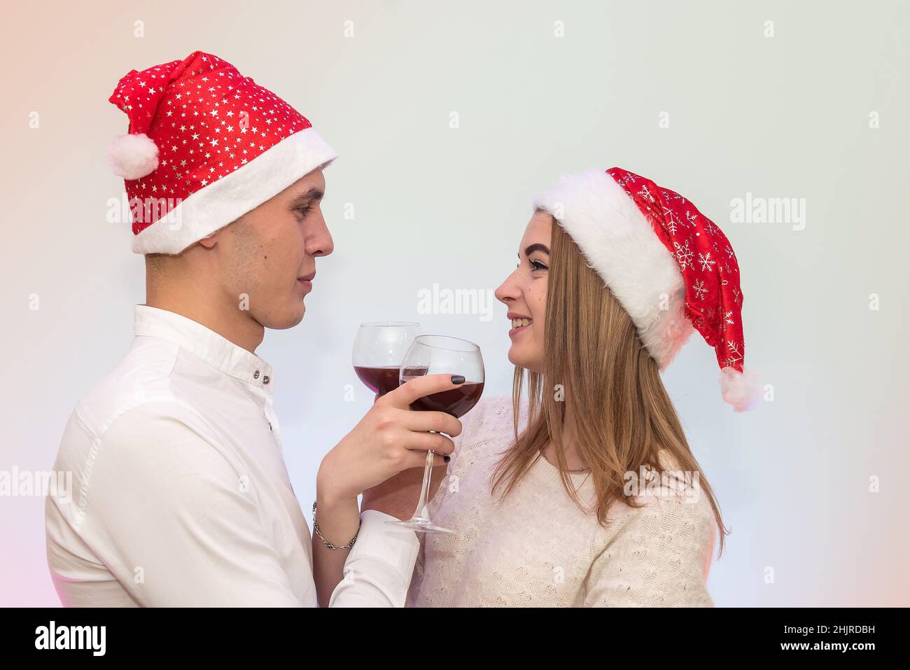 Young man pouring wine into glasses to his girlfriend. Valentine's celebration concept Stock Photo