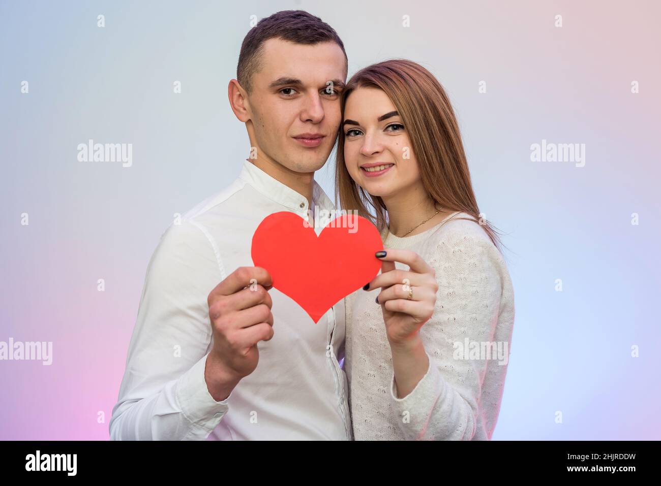 Couple in love holding red heart. Love and dating, celebration of St. Valentine's Day Stock Photo