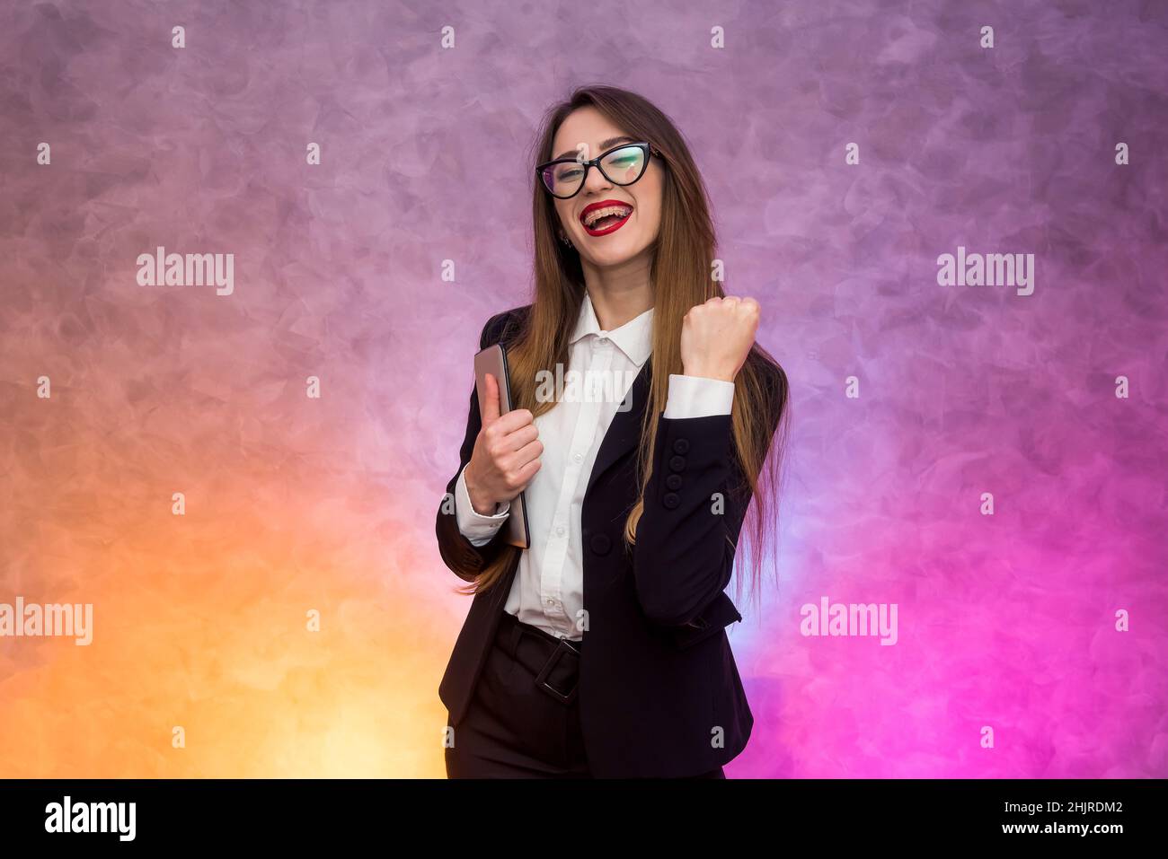 Business concept. Stylish businesswoman in elegant suit posing on abstract background Stock Photo