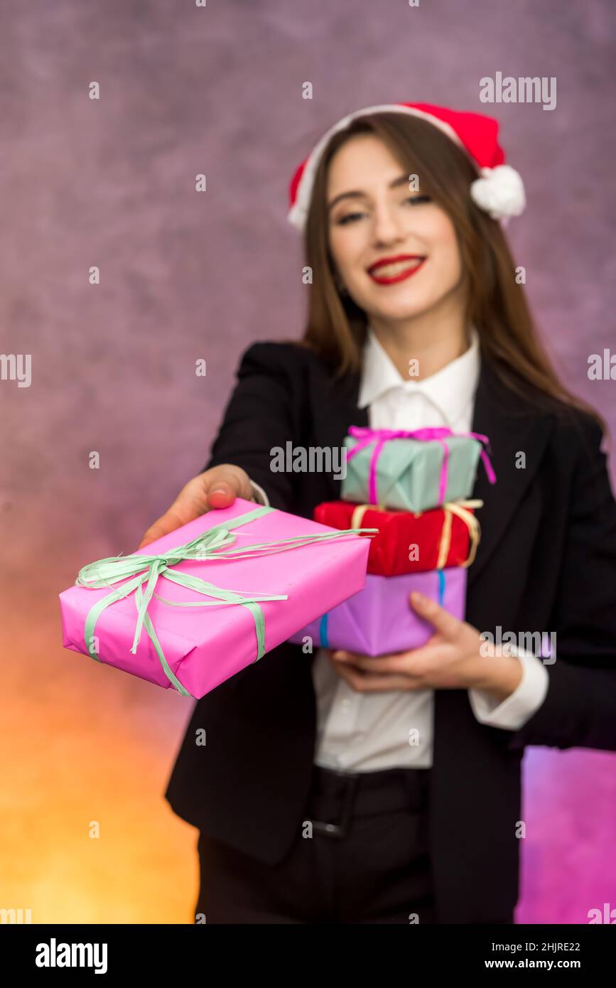 Christmas presents concept. Beautiful woman holding colorful present boxes Stock Photo