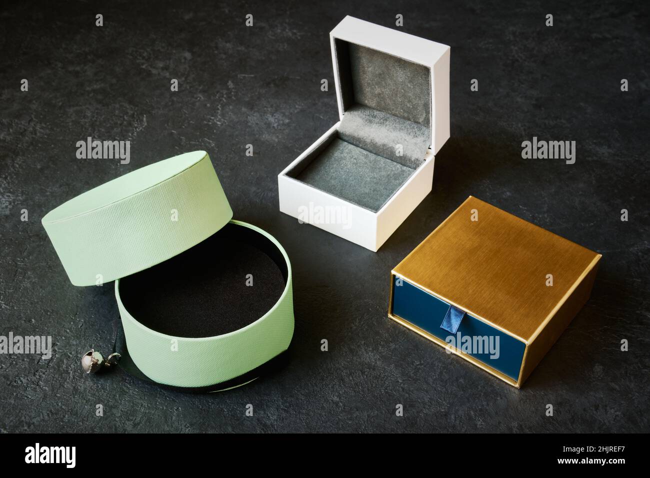 3 beautiful empty jewelry boxes close up on dark gray background Stock Photo