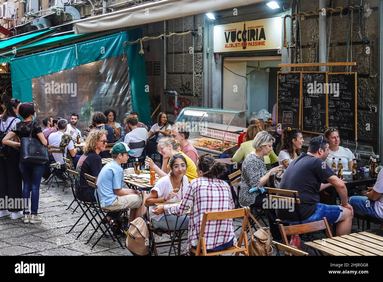 Palermo, Italy - October 23 2021: Local people and tourists have a drink in a street bar in the historic Vucciria market in Palermo in the largest cit Stock Photo