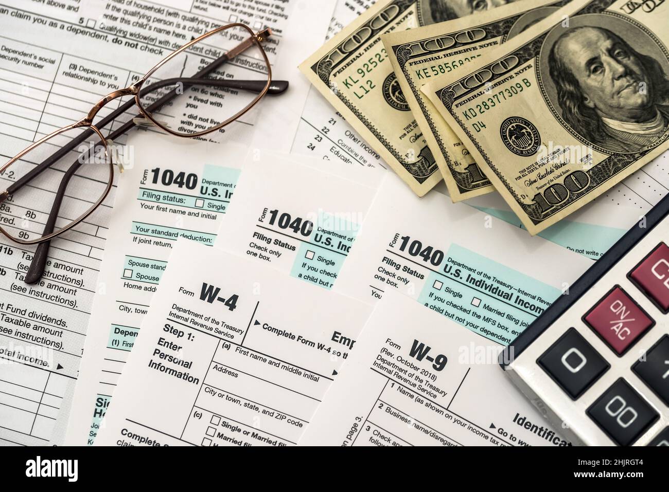 Tax form with dollar, calculator and pen Stock Photo