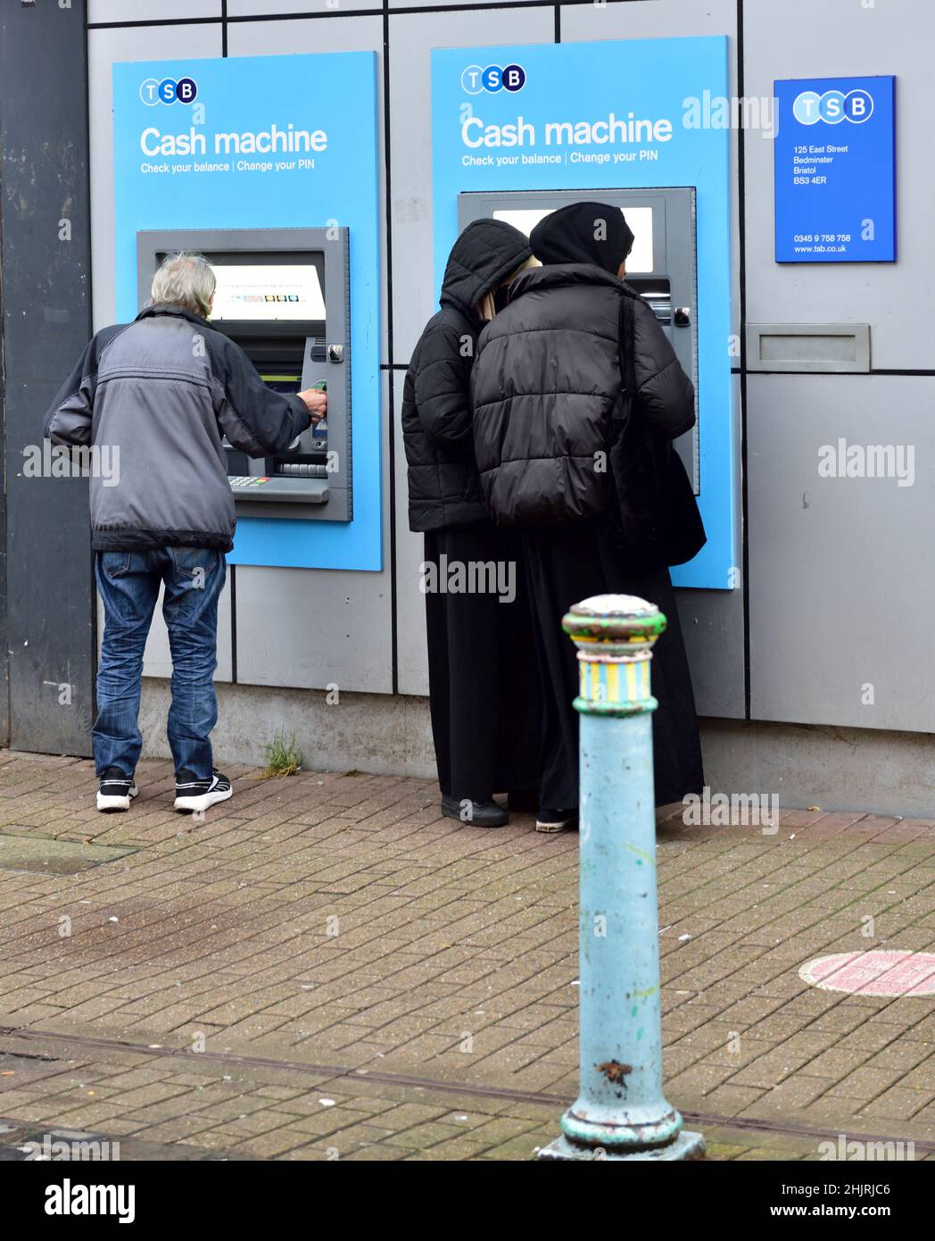 People using cash machine mounted in wall of TSB bank Stock Photo