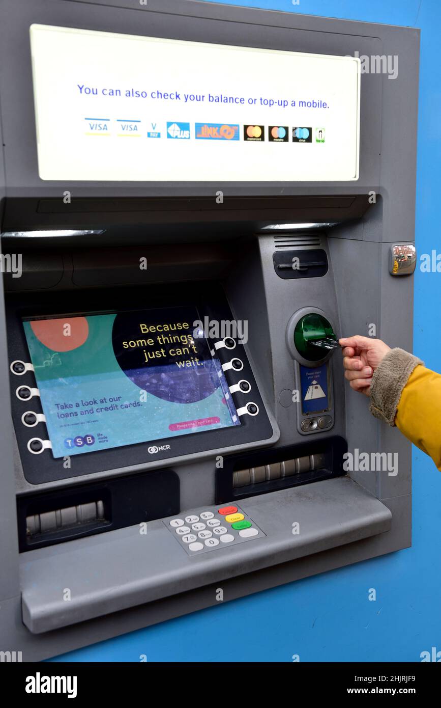 Cash machine, putting card into machine for cash withdrawal Stock Photo