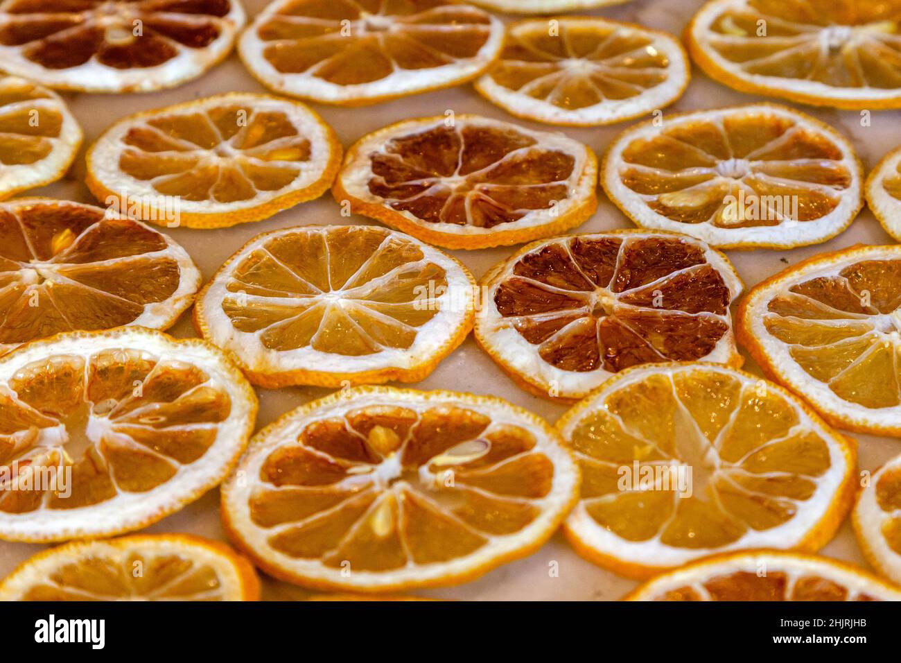 Dried oranges and lemons on a marble counter Stock Photo