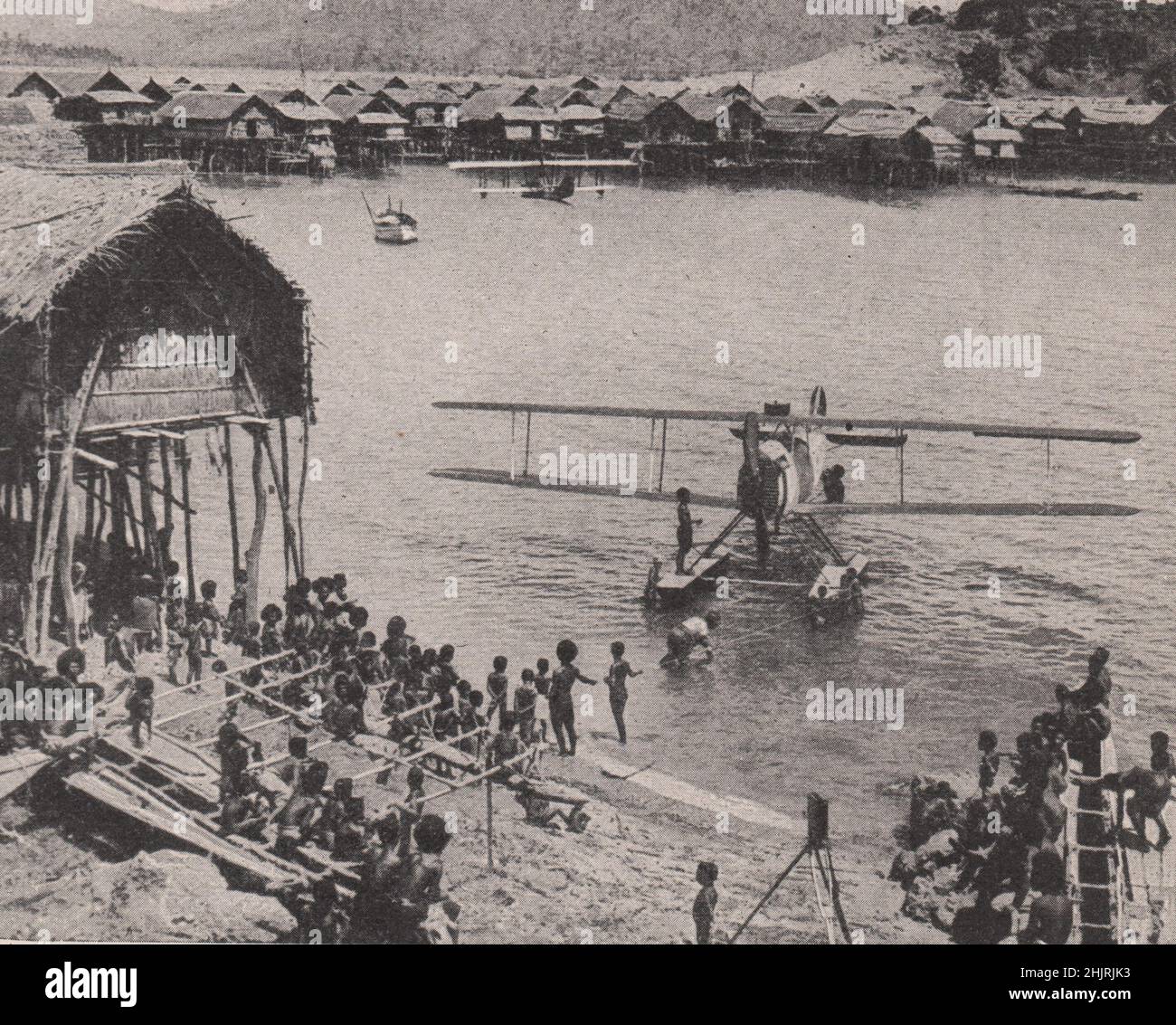 Seaplanes in the harbour of a pile village in Papua. Papua New Guinea. New Guinea (1923) Stock Photo