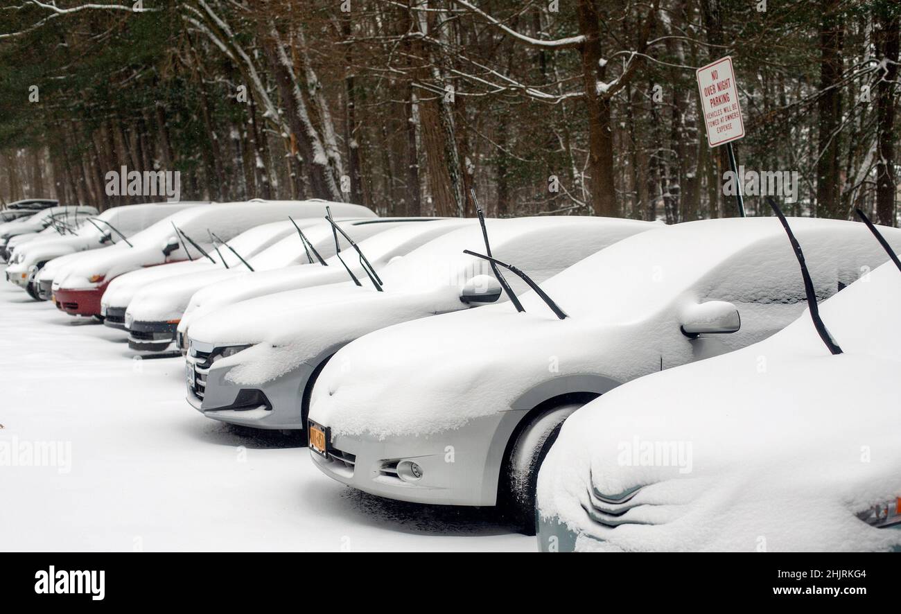 Cars with their windshield wipers up to prevent icing during a snow storm Stock Photo