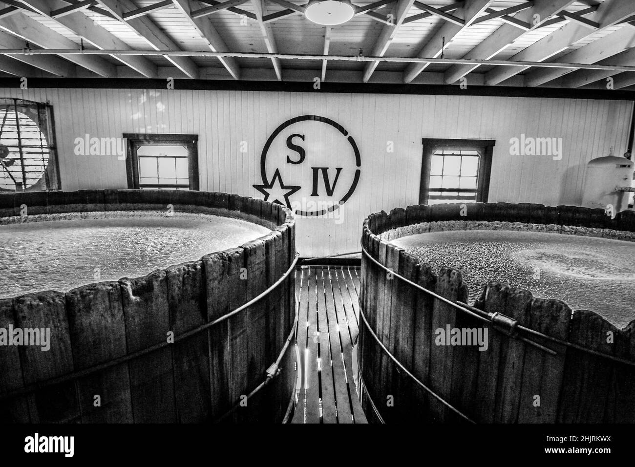 Watching bourbon ferment in these old wooden fermenters in Kentucky. Stock Photo