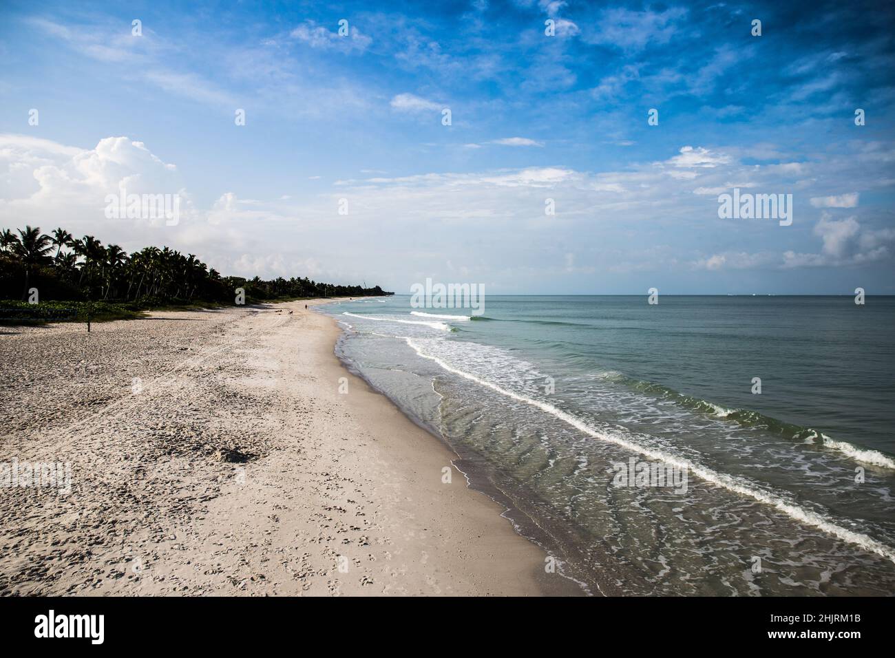 Let the leading edge of this beach lead you away down the shore. This is a beautiful view down the shore line of the beach in Naples Florida. Stock Photo