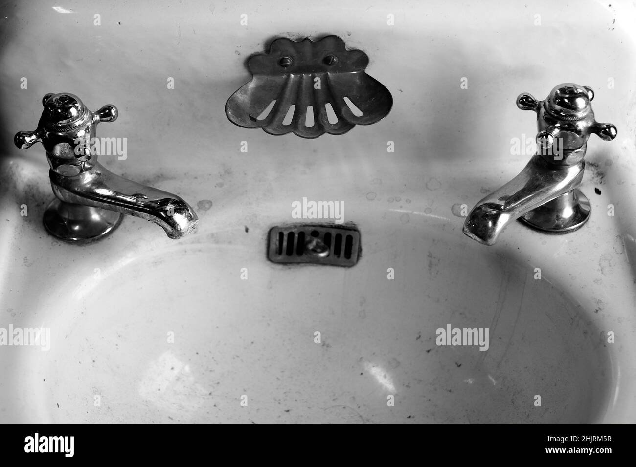 Old fashioned antique vintage bathroom sink and faucets for hot and