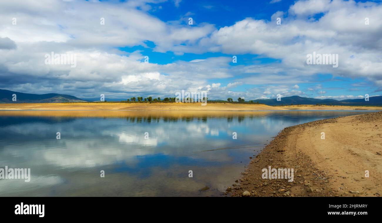 The cloudy sky reflected in the water of the lake Stock Photo - Alamy