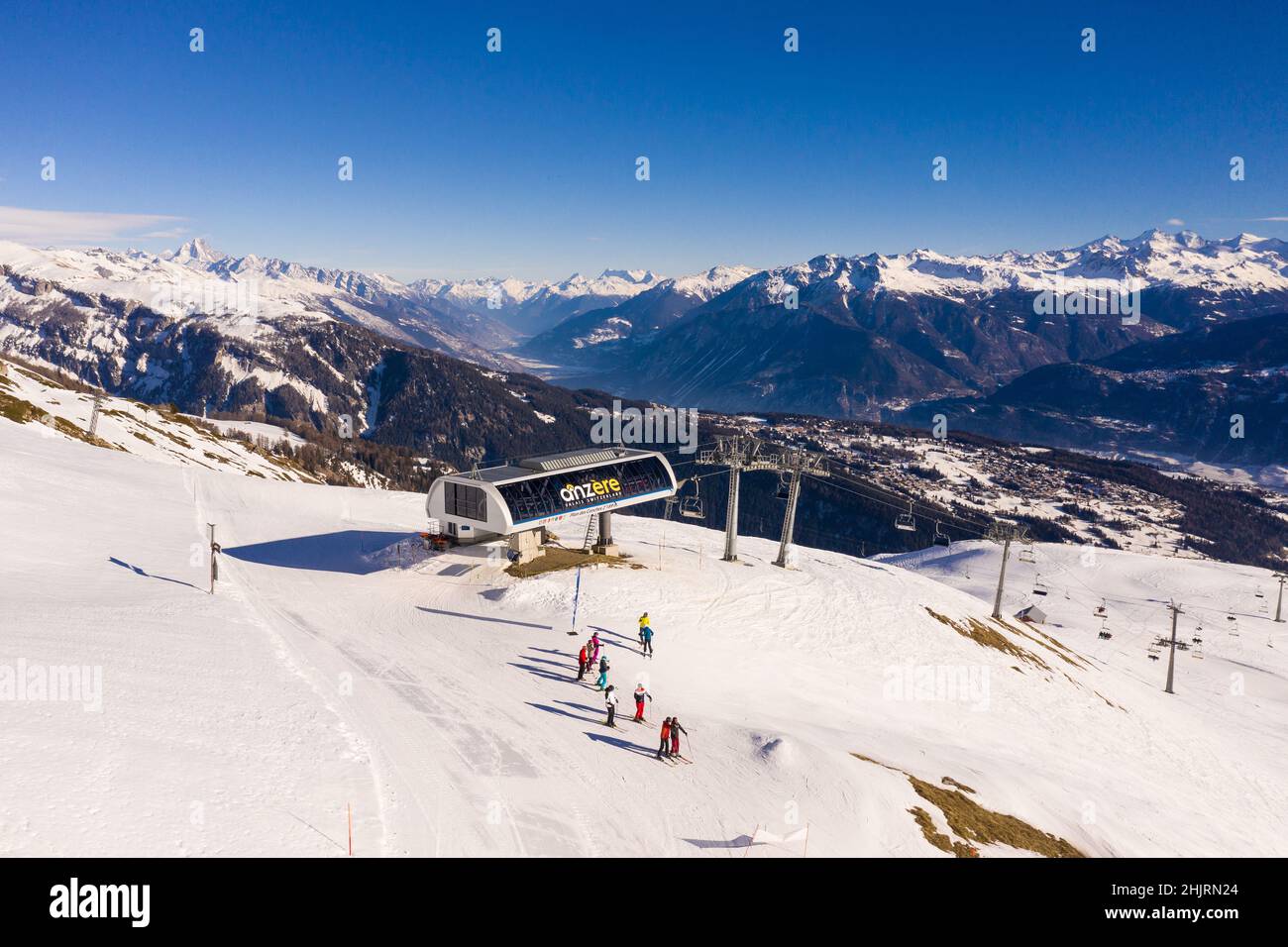 Anzere, Switzerland - January 28 2022: Aerial view of skiers about to go downhill on the Anzere ski resort from the Plan des Conches chair lift in Val Stock Photo